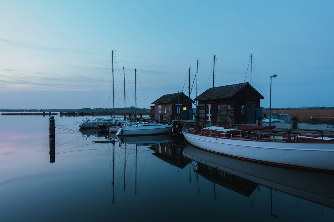 Small Danish fishing harbor with wooden boats at sunset