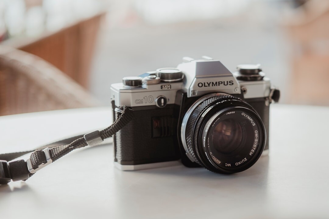 Vintage camera on a wooden table with photography equipment